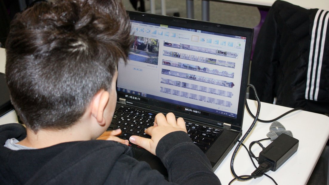 Students editing video on their laptop