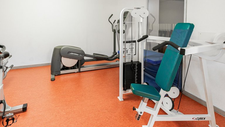 Fitness studio with weight bench and cross trainer